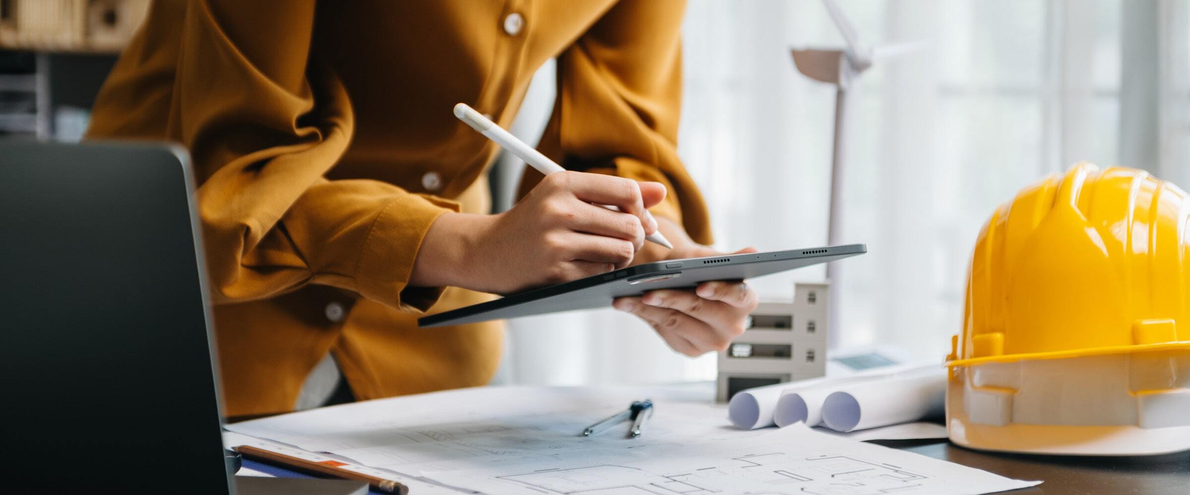 VPO-banner-woman-tablet-hardhat-desk-laptop-min